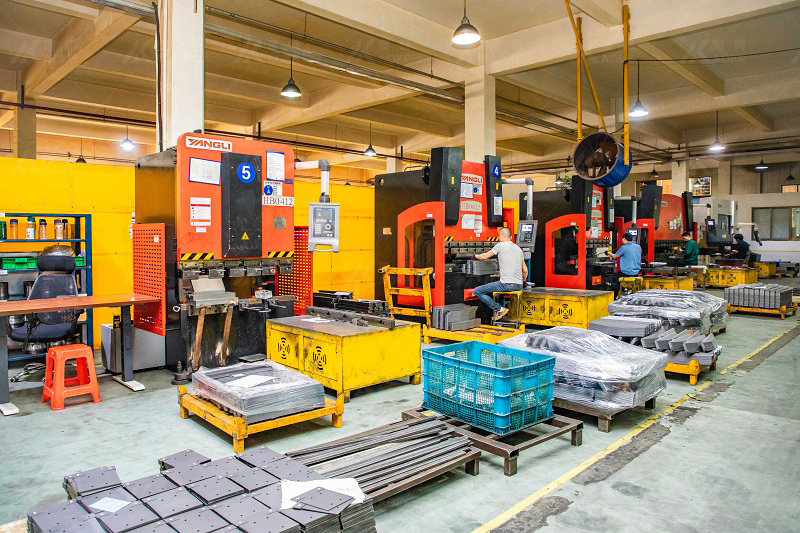 Aoke's workers operate machines in a sheet metal shop