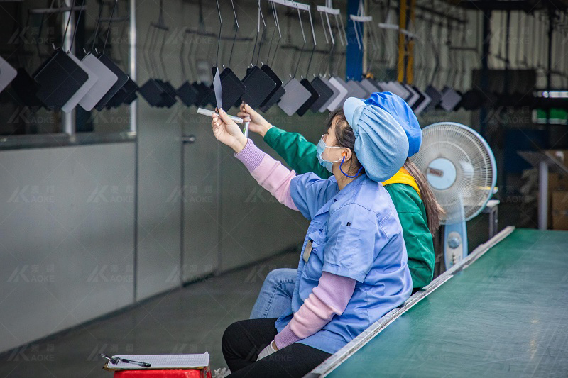 Workers are checking the painting of standing table parts